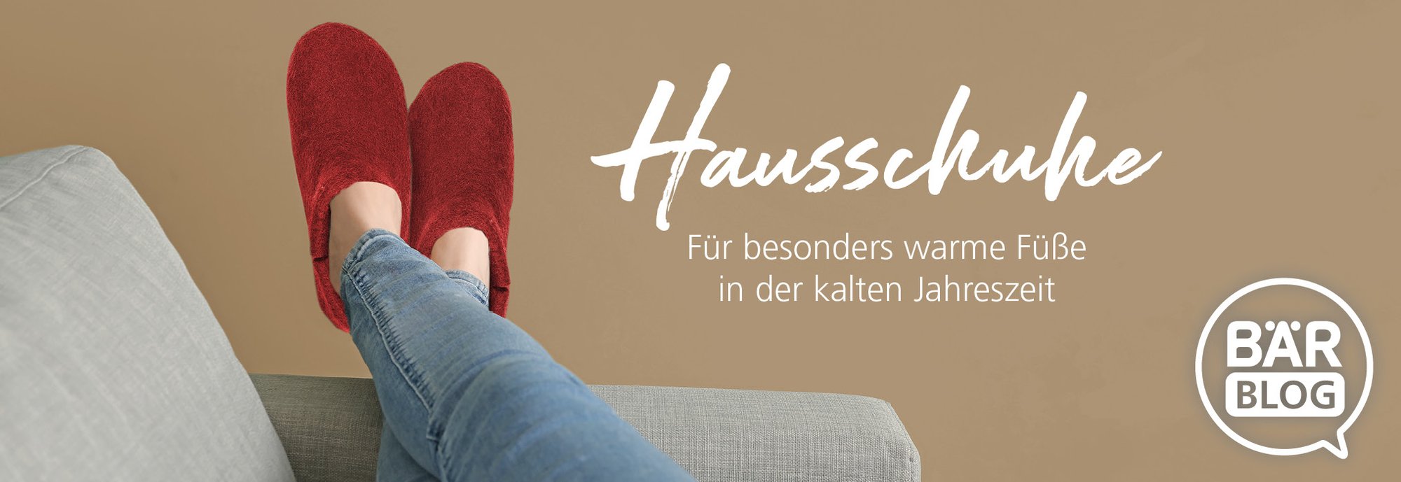 Comfortable red slippers keeping feet warm during winter on a couch Person wearing red slippers resting comfortably on a couch with legs crossed