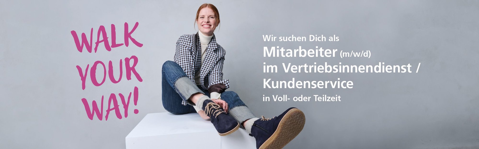Lächelnde Person sitzt auf weißem Podest, Text: "Walk Your Way" und Jobangebot im Vertriebsinnendienst/Kundenservice