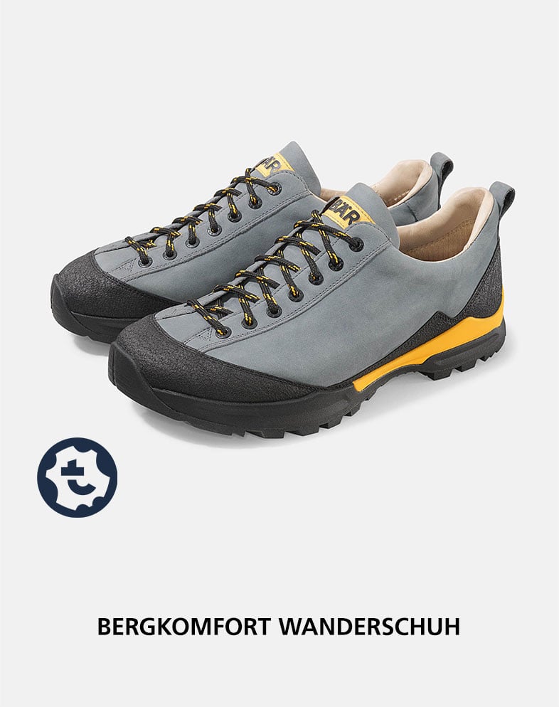 Gray and black hiking shoes with yellow accents, designed for mountain comfort and durability.