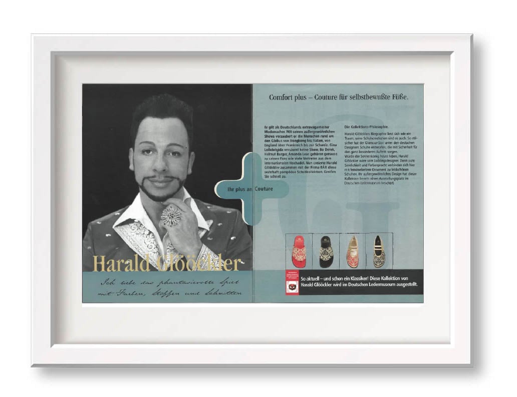 Framed artwork displaying an advertisement for Harald Glööckler's fashion design with text and images of shoes.