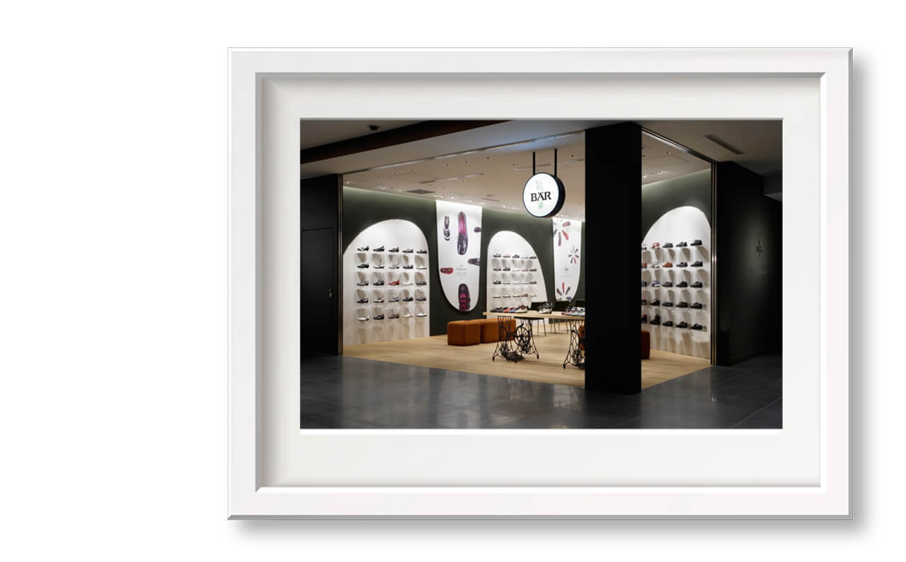 Interior view of a shoe store with wall displays and seating