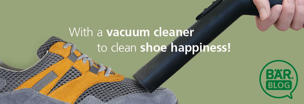 Vacuum Cleaner Cleaning a Shoe for Perfect Shoe Care Hand using vacuum cleaner to clean a gray and orange shoe