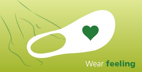 Comfortable Sock with Heart Design - Wear Feeling Illustration of a comfortable sock with a heart design, promoting the concept 'Wear Feeling' on a green background