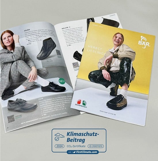 Open catalog showcasing the autumn shoe collection with various sneaker designs and a climate protection contribution seal.