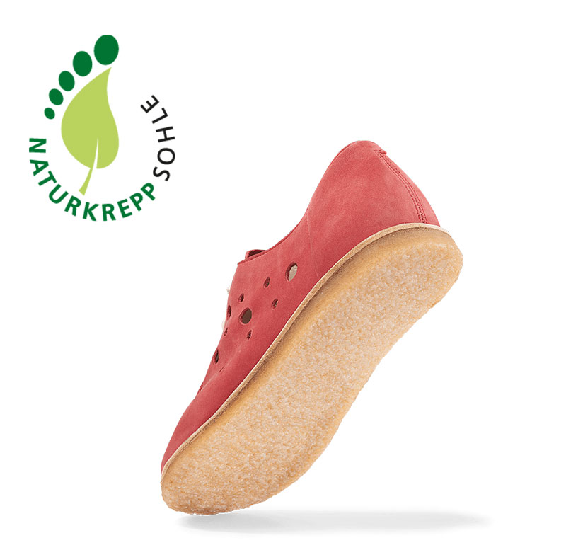 Red Shoe with Natural Crepe Sole Red shoe featuring a natural crepe sole and ventilation holes, highlighting comfort and style.