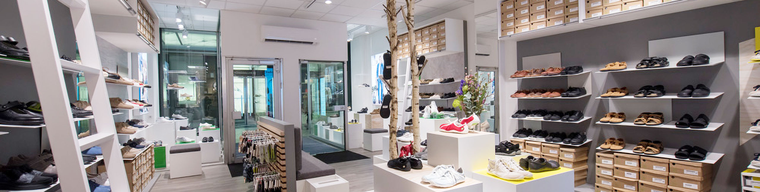 Modern shoe store with stylish interior design A modern shoe store interior with shelves full of various shoes, casual ambiance, and decorative elements