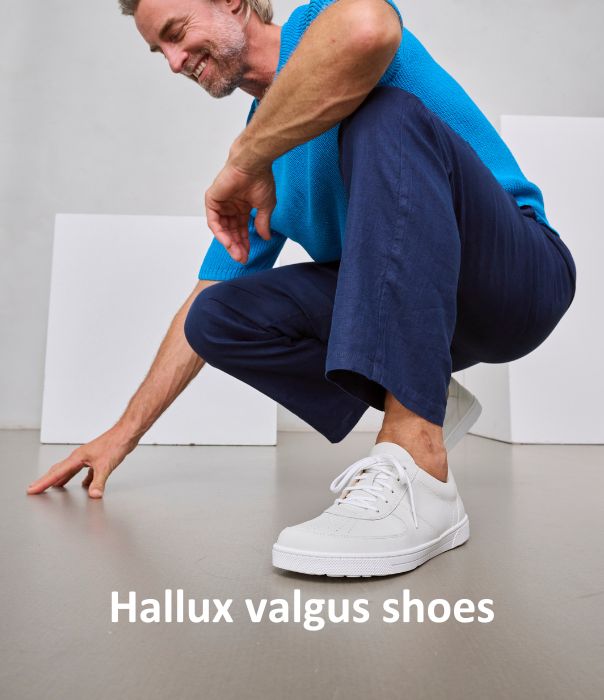 Man wearing comfortable white shoes suitable for hallux valgus