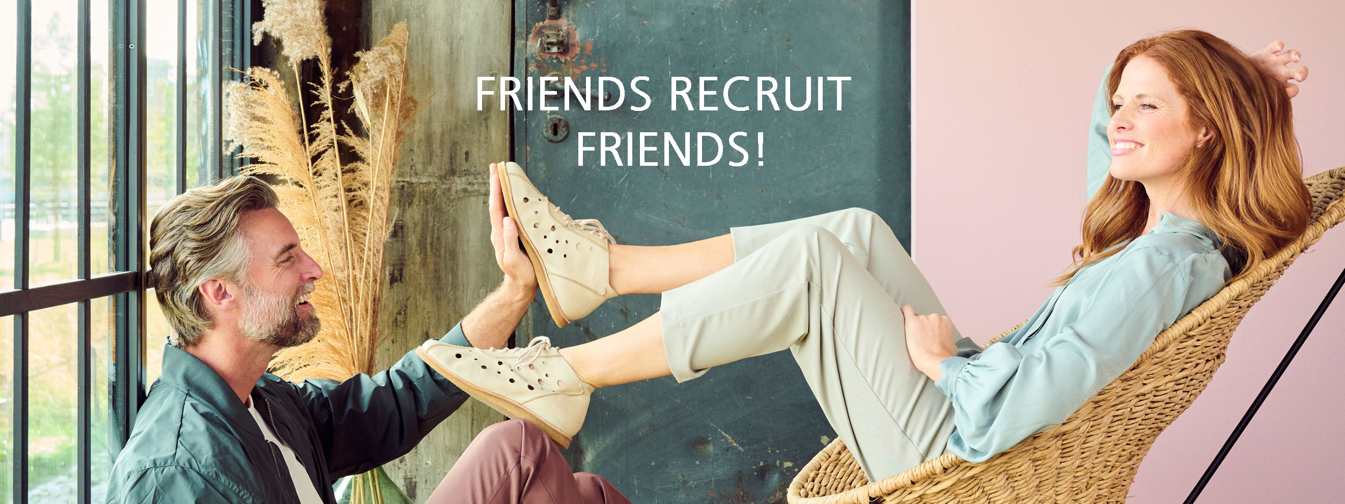 Friends Recruit Friends - Relaxing in Style Man and woman enjoying a relaxed moment with smiles, promoting friends recruitment program.