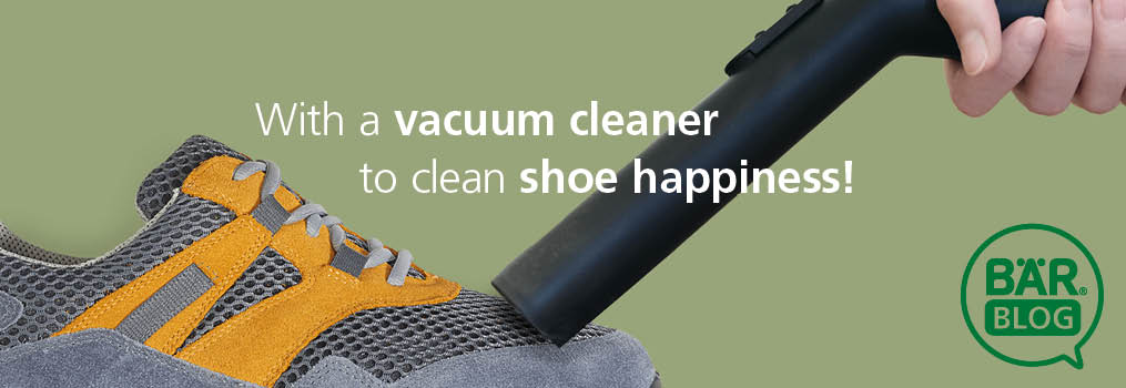 Vacuum Cleaner Cleaning a Shoe for Perfect Shoe Care Hand using vacuum cleaner to clean a gray and orange shoe
